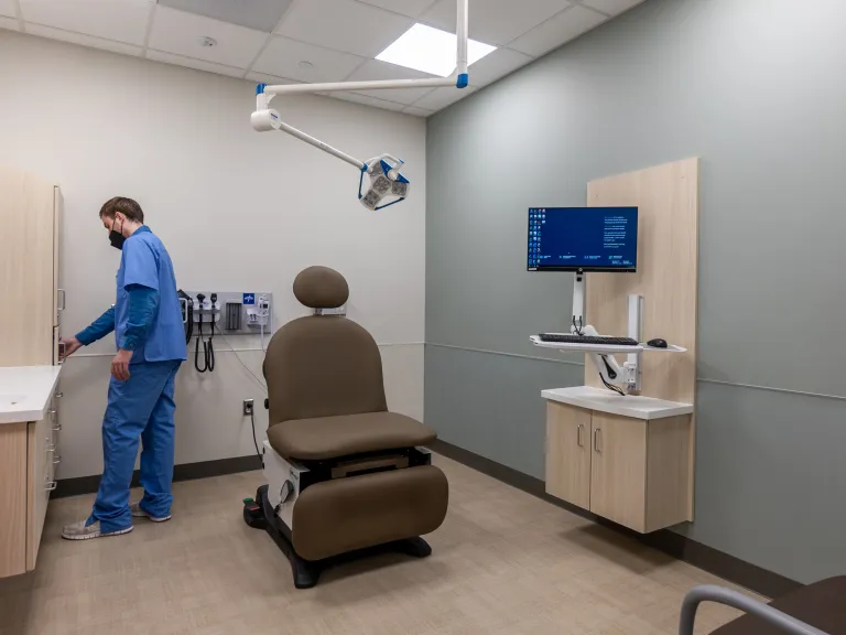 exam room with nurse in scrubs