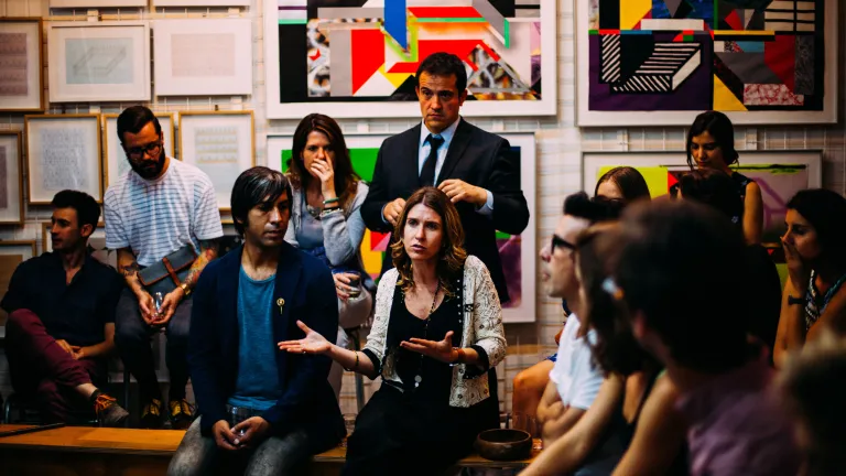 people in discussion at an art gallery
