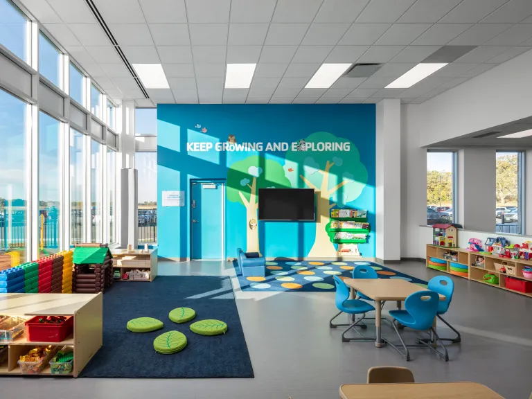 play room with colorful wall graphic and large windows