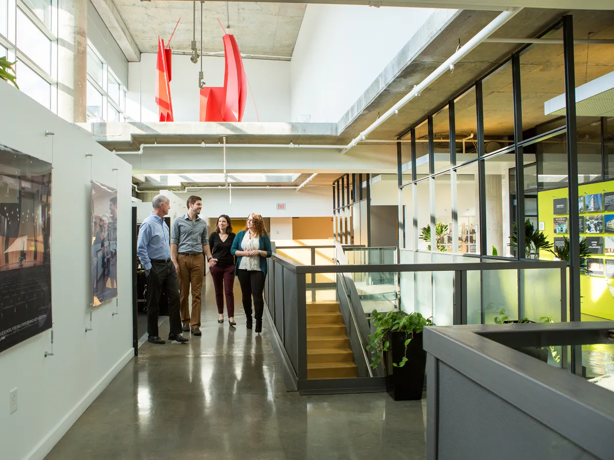Group of people walking down the corridor of the Columbus DesignGroup office.
