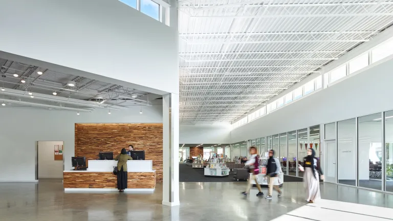 Interior of Northern Lights Columbus Library help desk on the left and open space on the right, featuring staff pick books