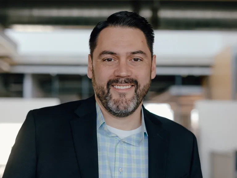 headshot of man with black suit