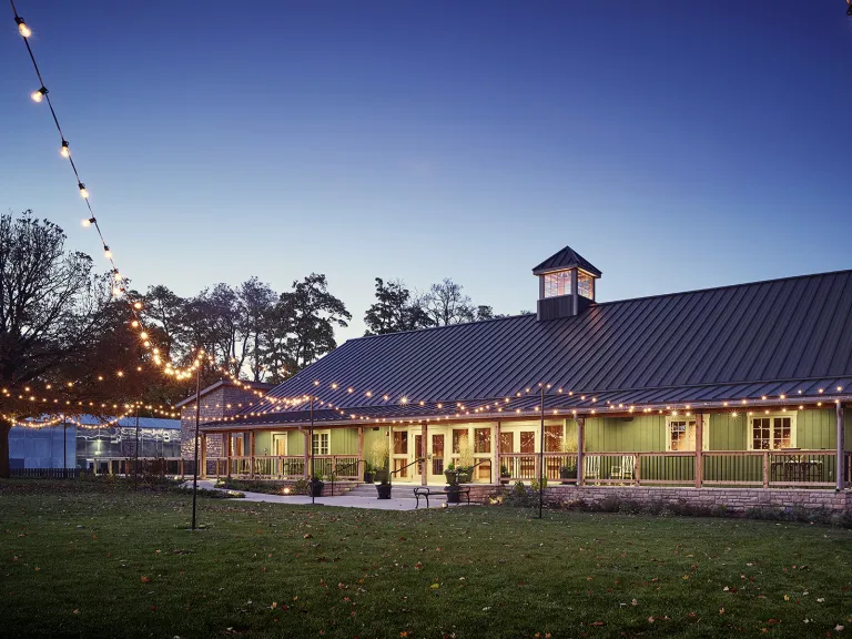 Exterior view of a barn style event space in the evening.
