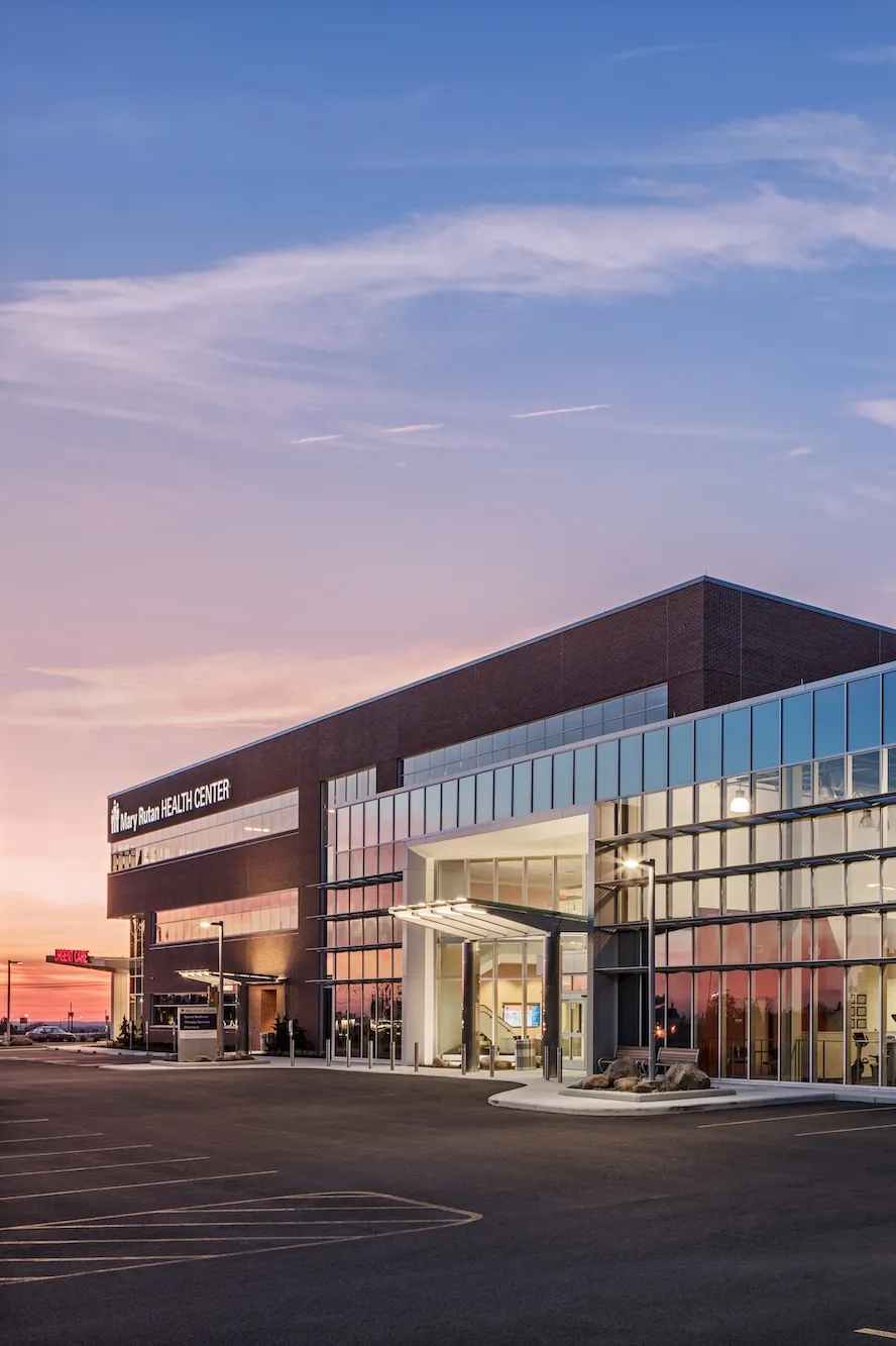 Exterior of Mary Rutan Hospital health center at dusk