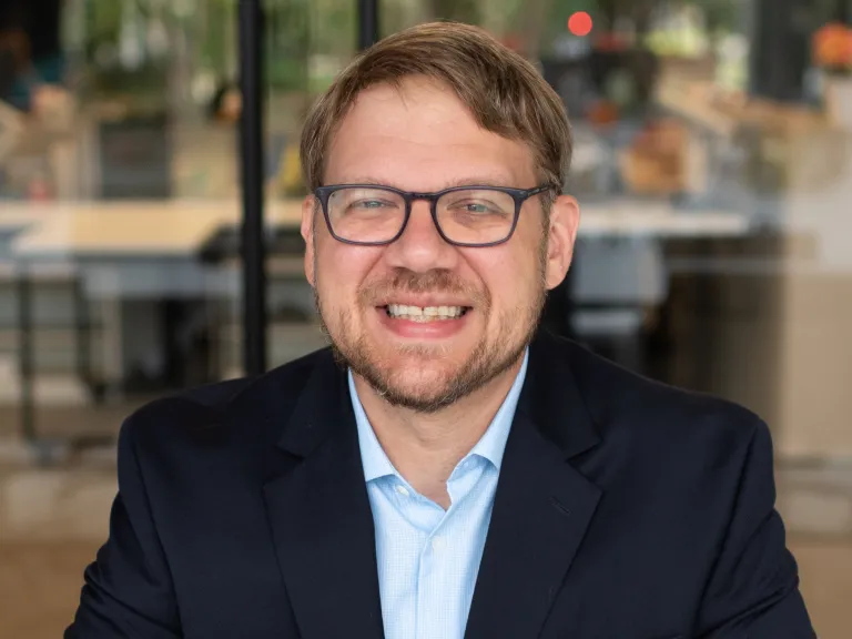 man with glasses and dark jacket