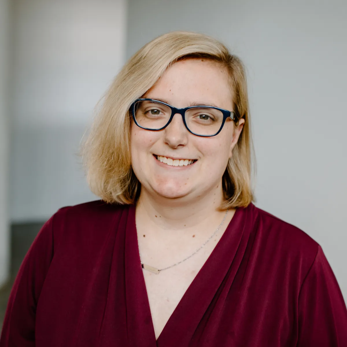 Marissa Andrews smiling, wearing a maroon blouse