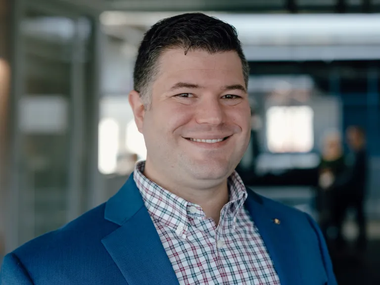 Headshot of man in blue suit