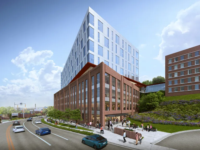 Exterior view of a mixed use building on a busy street.