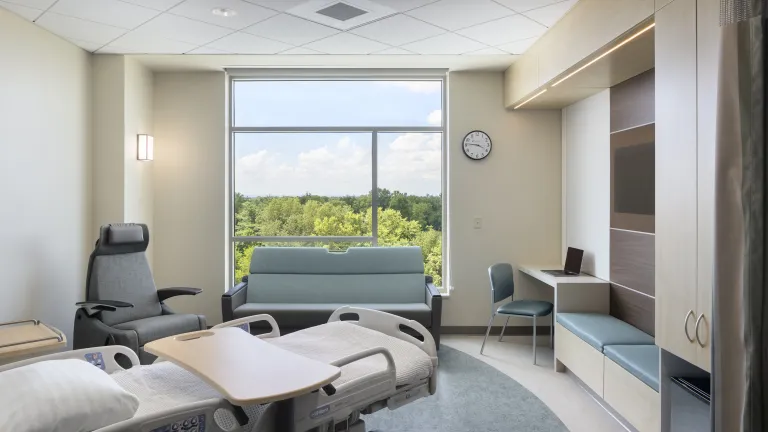 inpatient room with large window and nature views