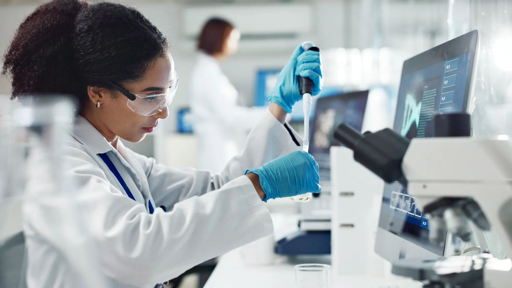 Woman using test tubes in a laboratory.