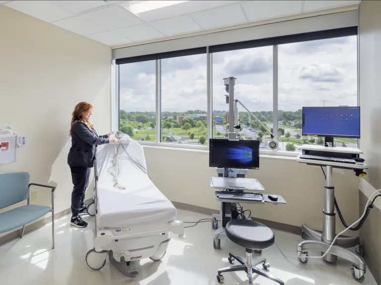Nurse organizing medical equipment in a patient room