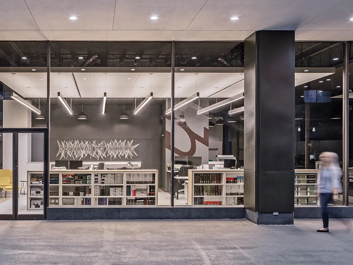 Exterior view of the Pittsburgh DesignGroup office in the evening, brightly lit from the inside.