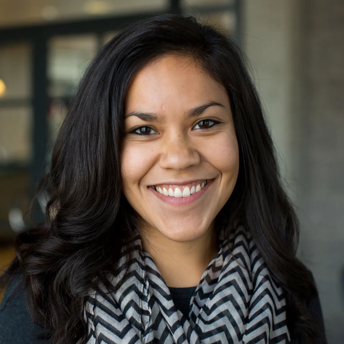 Shawna Foley smiling, wearing a black blouse and chevron scarf