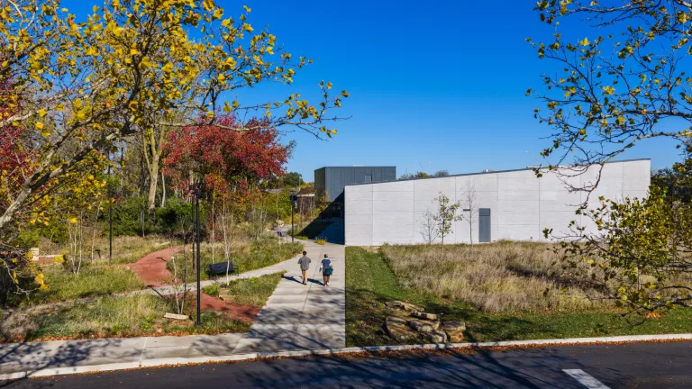 building with paneled facade and autumnal landscape