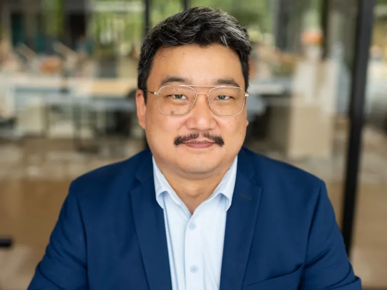 man with wireframe glasses and mustache